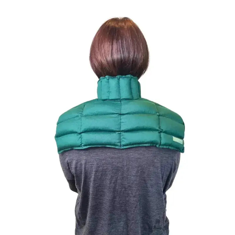 Model wearing green neck & shoulder wheat bag back view