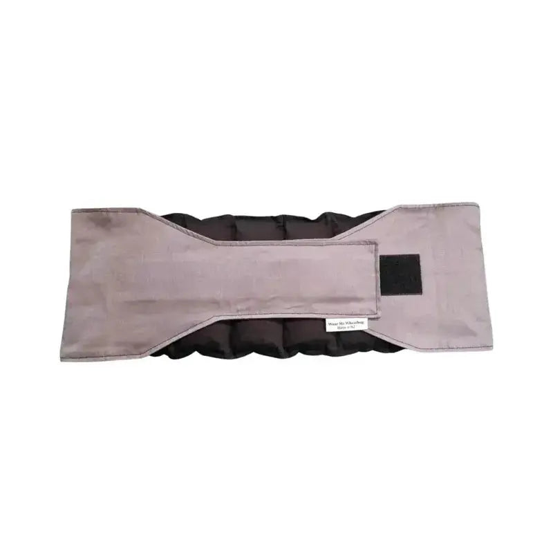 Grey waist wheat bag with velcro strap fastened, designed for lower back and period pain relief