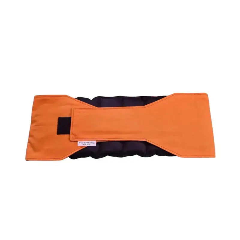 Orange waist wheat bag with velcro strap fastened, designed for lower back and period pain relief