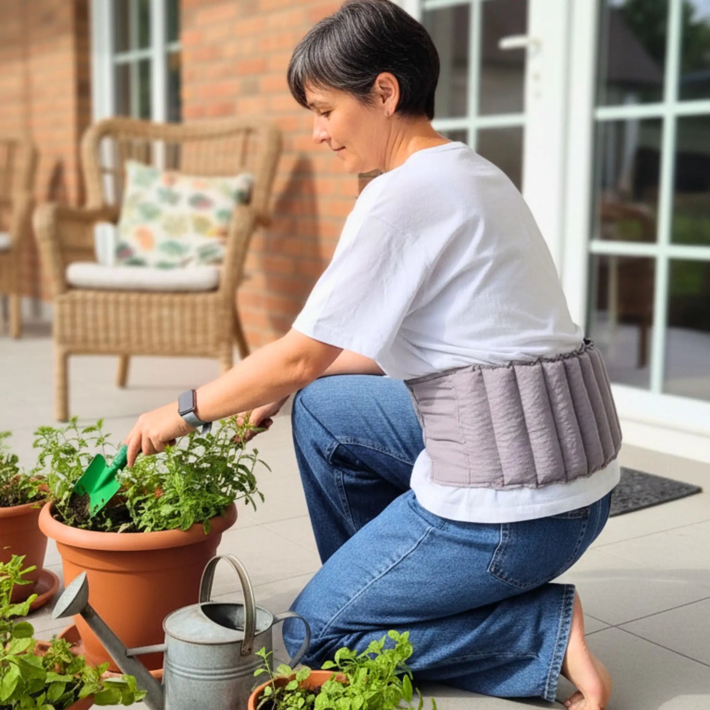 Lady gardening and wearing waist wheat bag