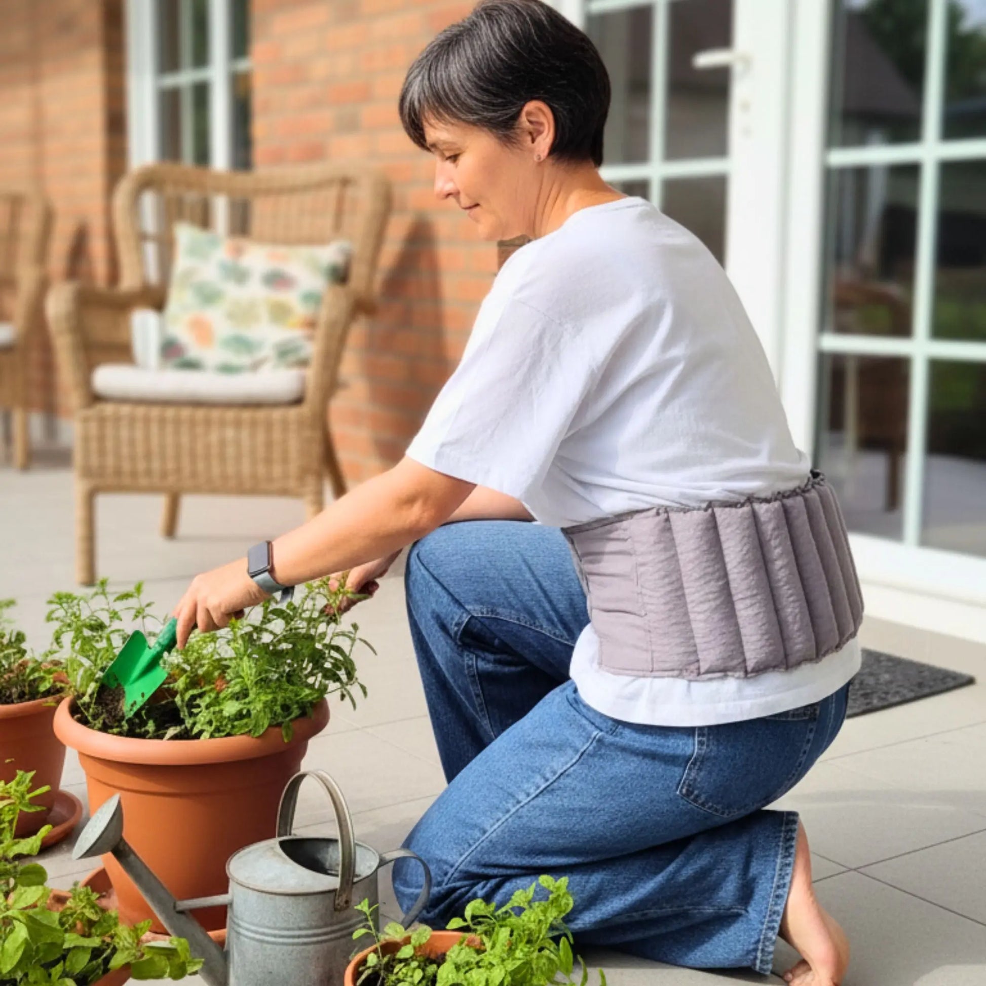 Lady gardening and wearing waist wheat bag