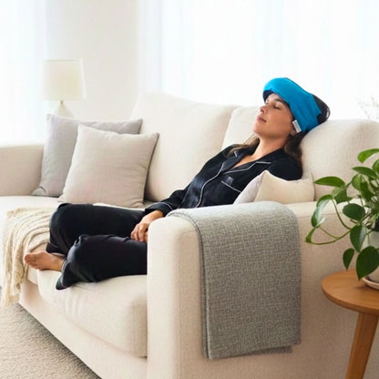 Lady laying on couch with a turquoise headache wheat bag on