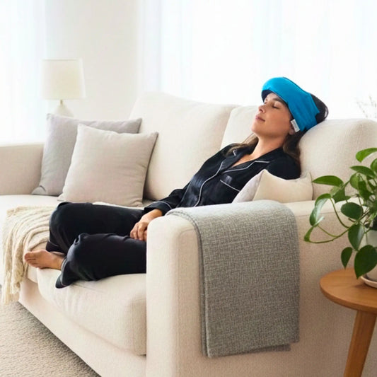 Lady laying on couch with a turquoise headache wheat bag on